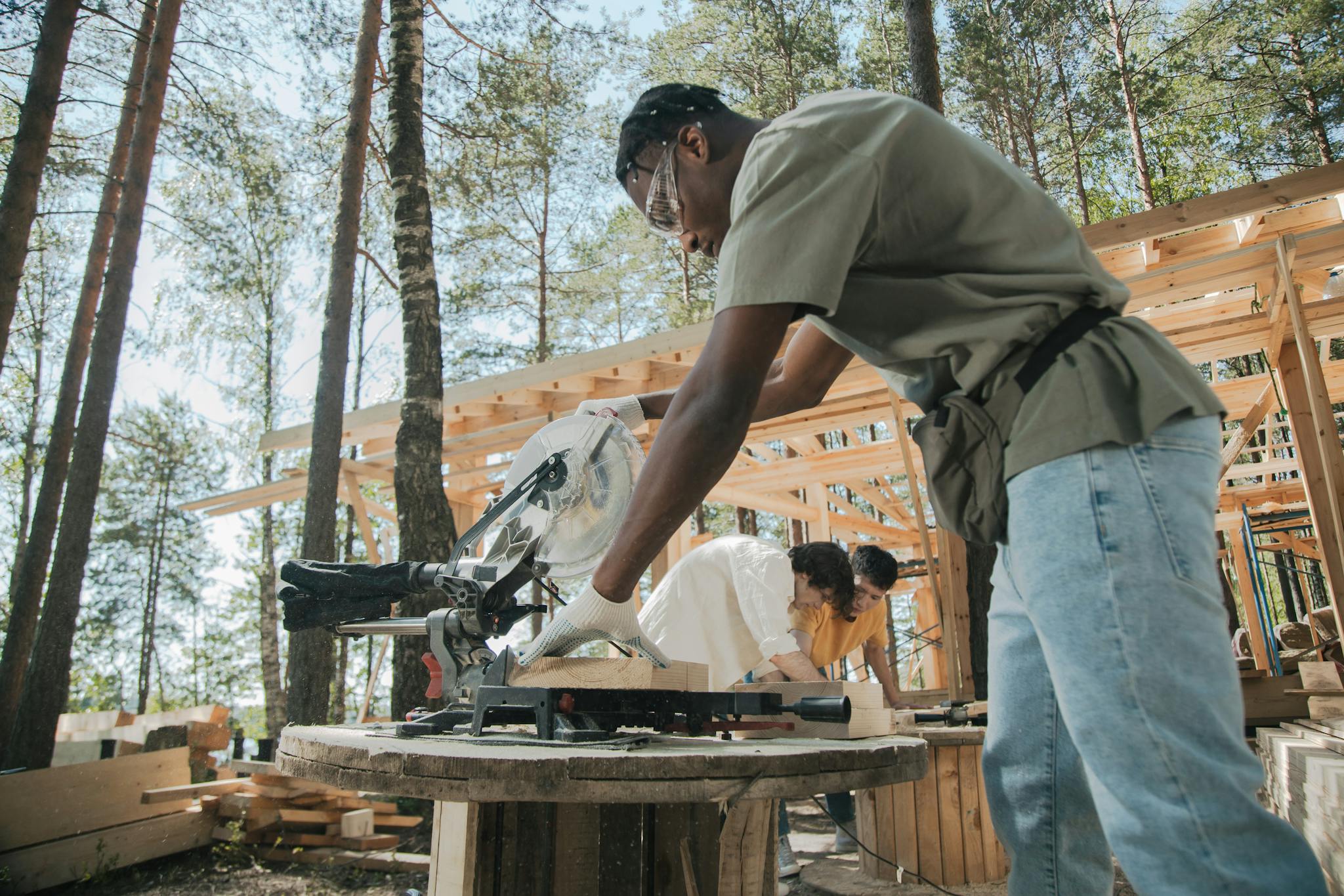 workers on a construction site cutting wood